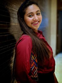 Portrait of smiling young woman standing outdoors