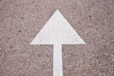 High angle view of arrow symbol on road