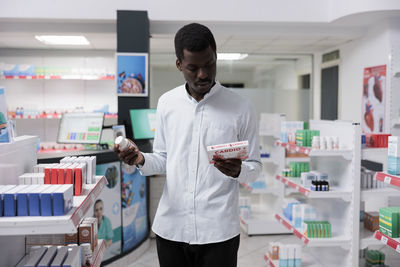 Side view of man standing in store