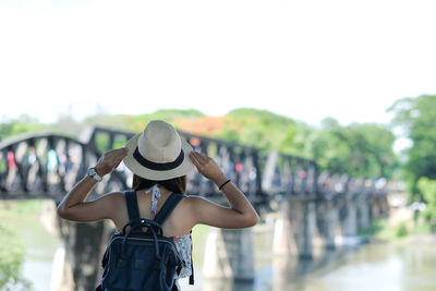 Rear view of woman in hat looking at bridge
