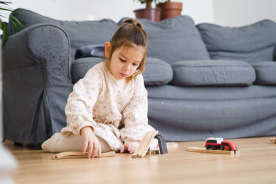 Cute girl playing with toy train