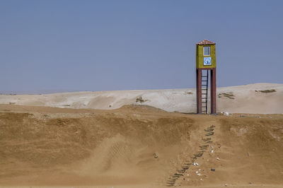 Scenic view of beach against blue sky