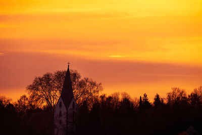 Silhouette trees against sky during sunset