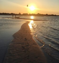 Scenic view of beach against sky during sunset