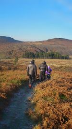 Rear view of people hiking