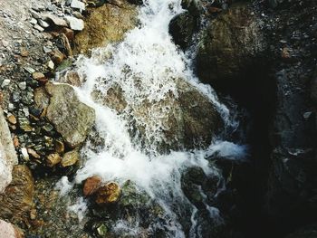 High angle view of waterfall amidst rocks