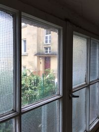 View of apartment building through window