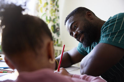 Bearded man looking at daughter