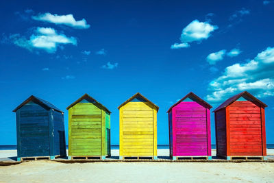 Beach huts against blue sky