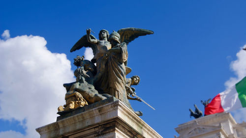 Low angle view of statue against blue sky