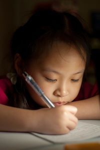 Close-up portrait of girl looking at home