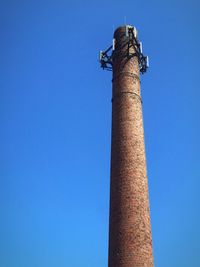 Low angle view of smoke stack against sky