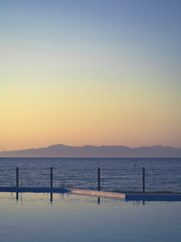 Scenic view of sea against clear sky during sunset