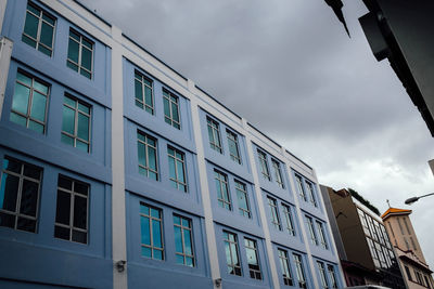 Low angle view of building against cloudy sky