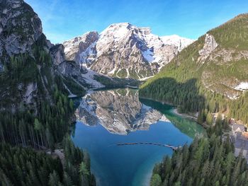 Scenic view of lake and mountains against blue sky