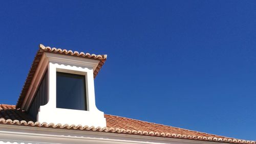 Low angle view of built structure against clear blue sky