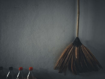 Close-up of glass bottle hanging on table at home