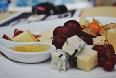 Close-up of chopped fruits in plate on table