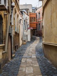 Alley amidst buildings in city