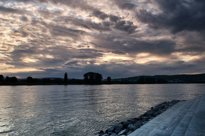 Scenic view of lake against sky at sunset