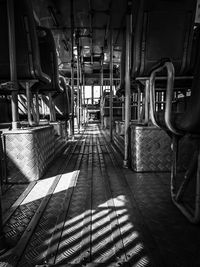 Black and white photo from backseat of the bus with sun rays coming from side