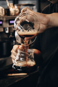 Close-up of hand holding coffee cup