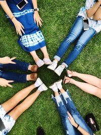 Low section of friends standing on grass