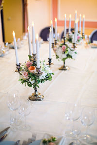 Candlesticks with candles at a wedding adorned with peonies