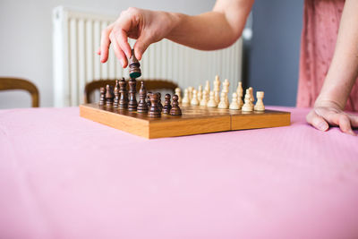 Midsection of woman playing chess