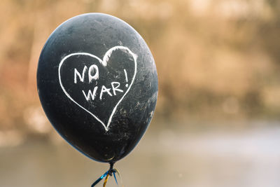 No war written in a heart on a black balloon during a peaceful demonstration against war