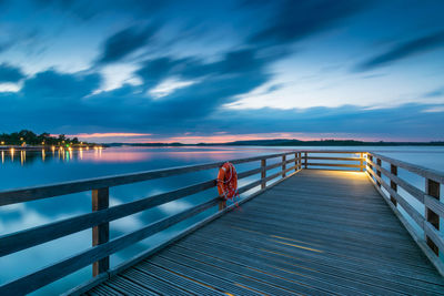 Pier over sea against sky at dusk