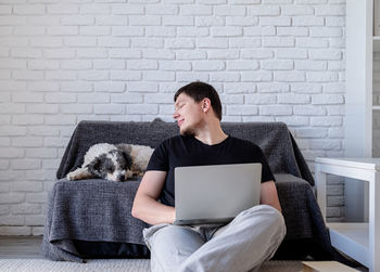 Full length of a man using laptop