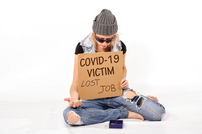 Woman sitting with text against white background