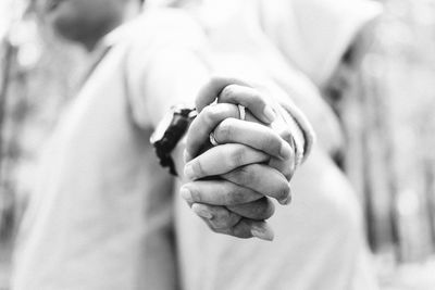 Low angle view of couple holding hands while standing outdoors