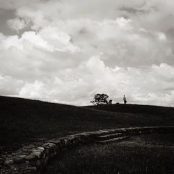 Scenic view of landscape against cloudy sky