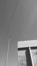 Low angle view of cables against clear sky