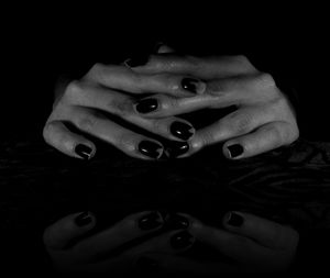 Cropped image of hand holding over black background