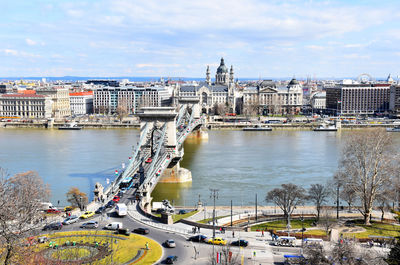 High angle view of river by buildings in city against sky