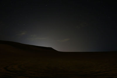 Scenic view of landscape against sky at night