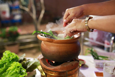 Cropped hand of person preparing food