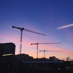 Low angle view of silhouette buildings against sky at sunset