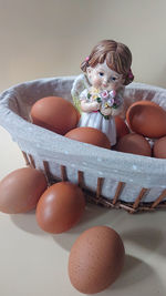 Portrait of woman sitting in basket on table