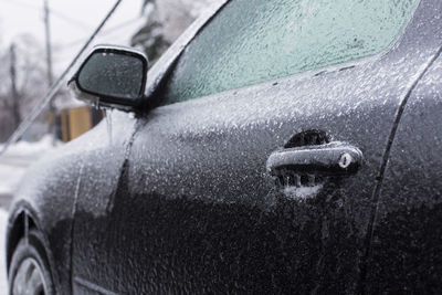 Close-up of wet car during winter
