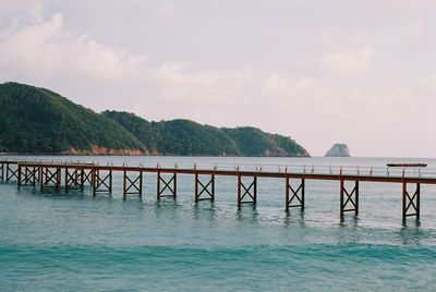 Pier over sea against sky