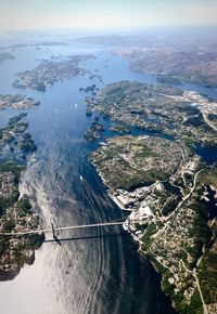 Aerial view of city and river against sky