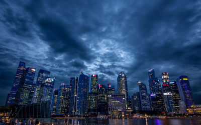 Low angle view of illuminated cityscape against sky