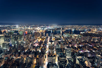 High angle view of city lit up at night