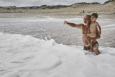 Full length of shirtless man in sea