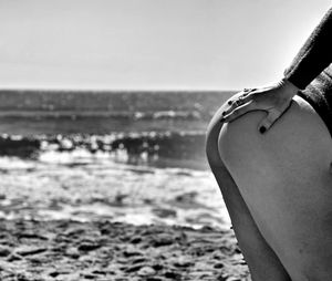 Close-up of man on beach against sky