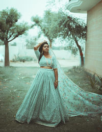 Portrait of young indian woman standing outdoors